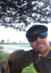 Mike the dog trainer from Happy Dog Training with dog in a Gold Coast park