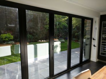 Sliding glass doors opening to a garden.