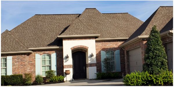 Before and after picture of a Lake Charles residence. Roof Wash.