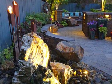 backyard landscaping with a fire pit and landscape lighting