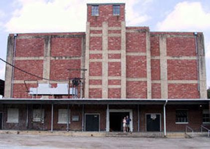 The Nelson Storage warehouse before renovation, a 4 story brick building with architectural salvage