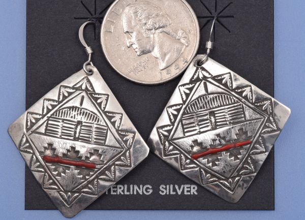 Older Navajo diamond-shaped earrings stamped with Navajo hogan and red coral insert