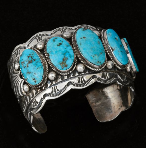 Wide intricately-stamped Navajo row cuff with five Kingman turquoise stones, by Marcella James. #1461