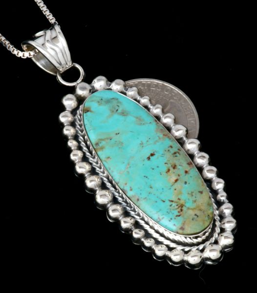 Bright finish turquoise pendant (with Sterling chain), by Navajo artisan Sheena Jack. #2108