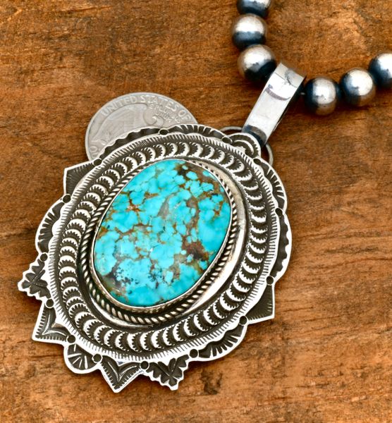 Large, intricately hand-stamped Navajo pendant by Freddie Maloney. #2169