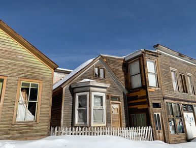 St Elmo ghost town buildings on a blue sky snow day.