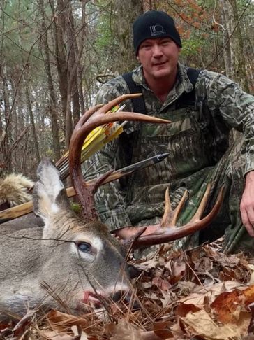 Travis Murray with a deer he hunted