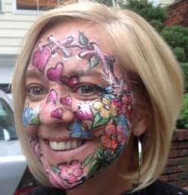 Woman with colorful floral face paint.
