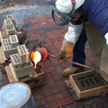 Pouring molten bronze at 2100 degrees F.