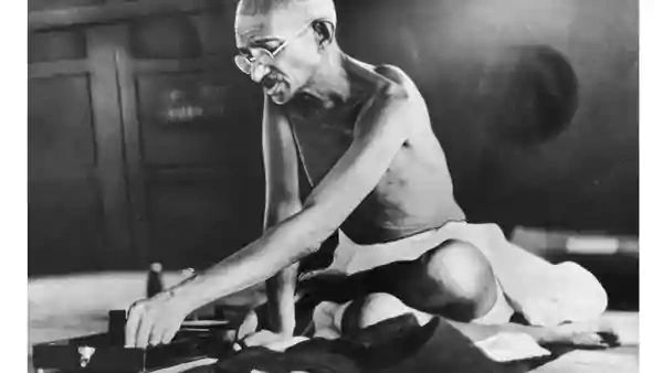 Mohandas (Mahatma) Gandhi at his spinning wheel
