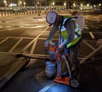 ACCG, Inc. worker doing concrete coring in the parking lot of Walt Disney World near Orlando, FL.