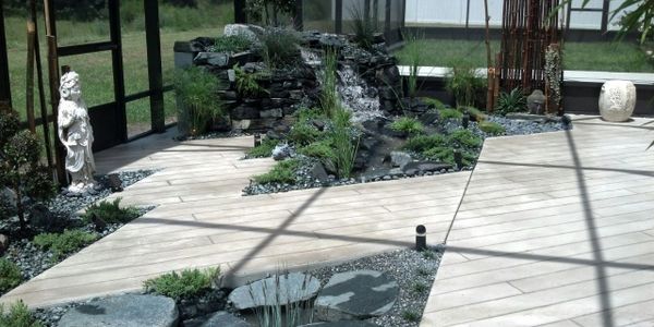 Beautiful decorative concrete forms flooring of a soothing Japanese garden. Bamboo and greenery.