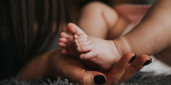 Baby feet being held by mothers hand x 