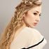 girl with long blonde wavy hair with side braid with flowers in white lace dress