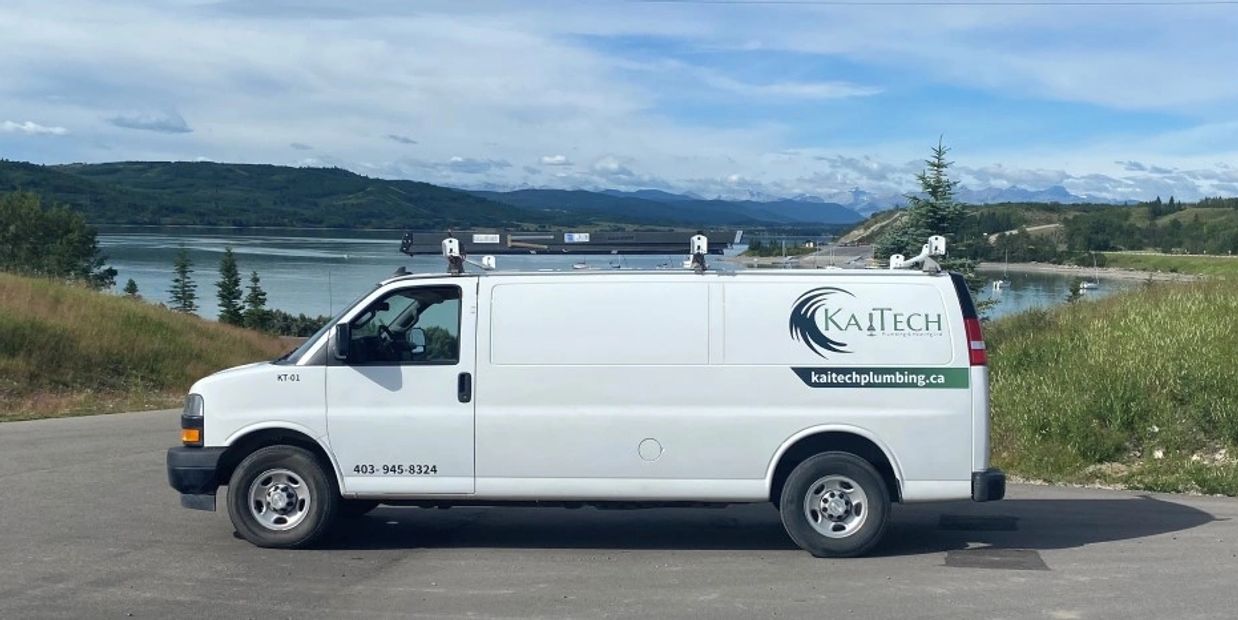 KaiTech Plumbing & Heating service van parked in Airdrie, - landscpae visible in background.