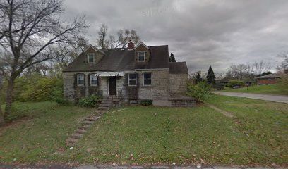 Abandoned gloomy stone house under cloudy sky.