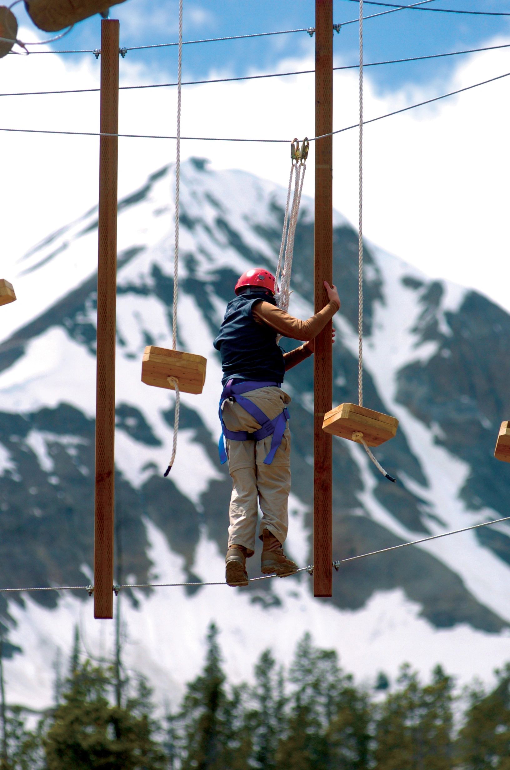 Participant on ski resort high ropes course