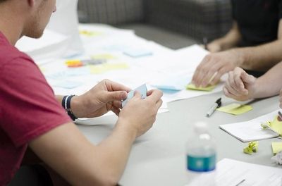 People working with notes on a table.