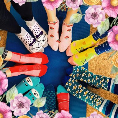 Pilates class membership group posing for sock picture