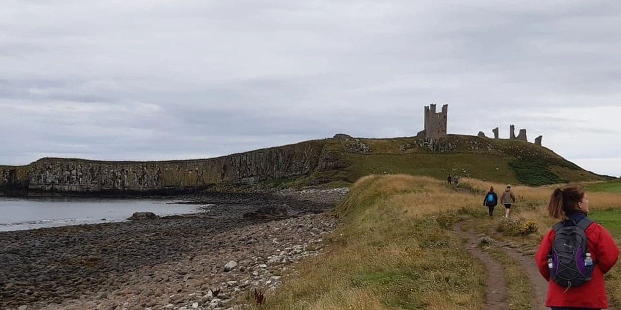 Denise Ward Virtual Assistant walking the coast path to Dunstanburgh Castle, Northumberland.