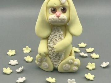 Handmade Rabbit made of edible modelling paste. Available in pink, blue or yellow. 
Approx 10cms. (4