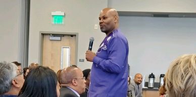 Picture of Dr. William Smith standing in the middle of a classroom presenting 