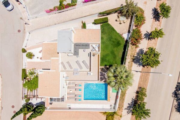 Aerial view of a house with pool and garden.