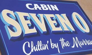 Cabin Seven O handpainted sign for a caravan park cabin at Picnic Point on the Murray River