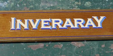 Handpainted house name property sign in white and blue on timber background. Inveraray.