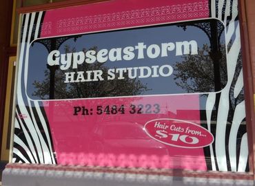 Window signwriting for Gypseastorm Hair Studio in Rochester