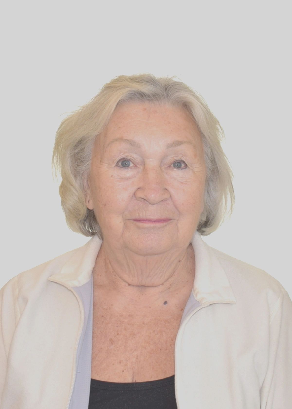 Elderly woman with light gray hair and a gentle expression.