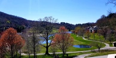 View of mountains, golf course, and country club