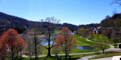 View of mountains, golf course, and country club