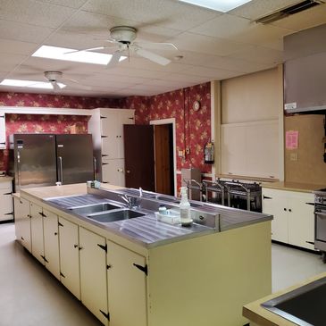 Large kitchen with a central island and double sinks.