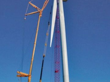 Wind turbine blade installation using cranes.