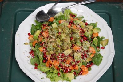 Pate of lettuce salad with pumpkin and pomegranate seeds.