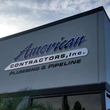 Main business identity signage. Dimensional acrylic and brushed aluminum logo and letters.