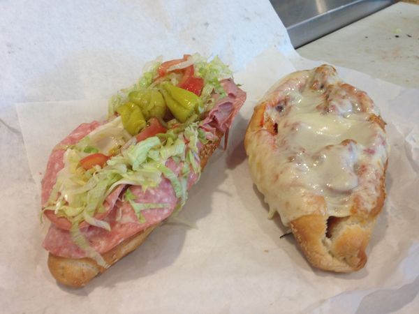 Picture of 2 Sandwiches. One is a cold torpedo with cold meats cheese lettuce and tomato. the other 