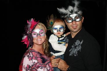 family posing inside big shot photo booth