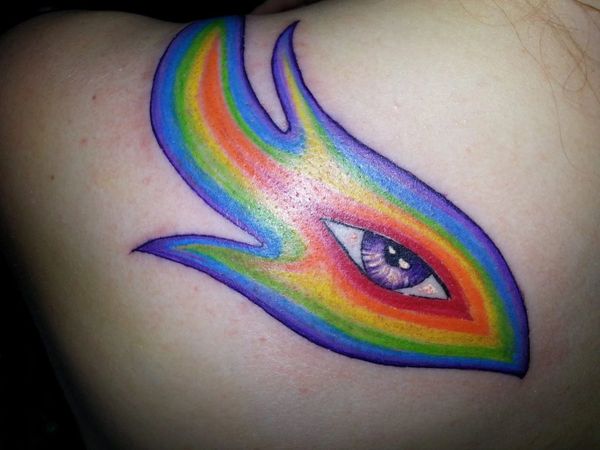 Color tattoo of an eye surrounded by a rainbow swirl.