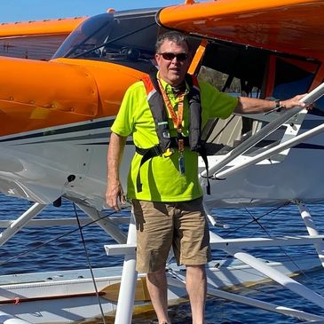 David Lackey, seaplane training instructor stands on the float of the Maule Amphibian