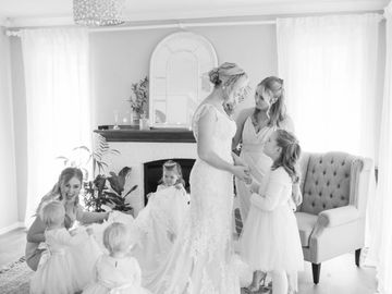 Bride surrounded by her bridal party members. Bridesmaids and flowergirls.