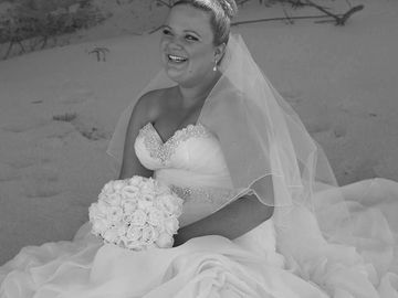 Bride happily sitting and smile at her new Groom on Norah Head Beach 