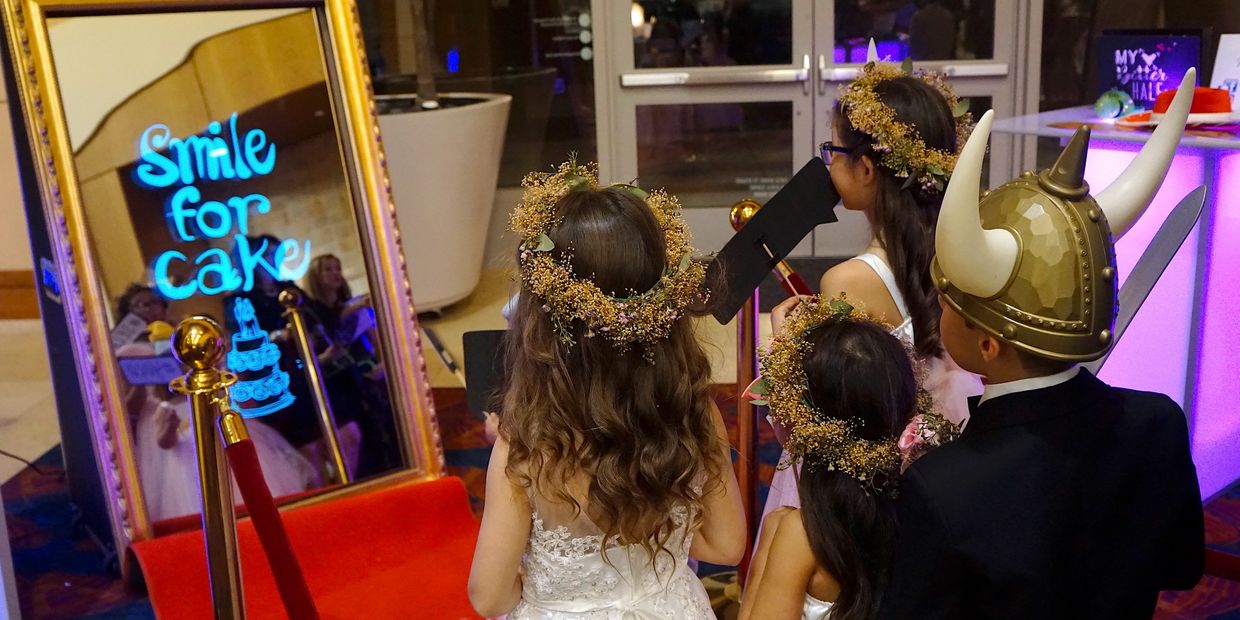 kids taking selfies in magic mirror photo booth displays animation props