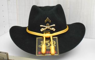 Black Color Cav Hat on display with a label 