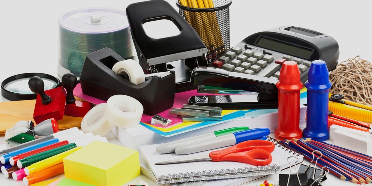 office supplies including tape dispenser, scissors, pencils, rubber bands, markers, calculator