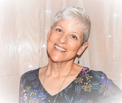 Smiling elderly woman with short white hair.