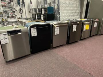 Row of dishwashers displayed in a store.