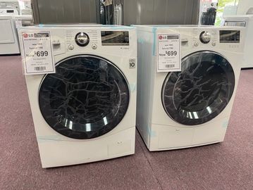 Two LG front-load washers priced at $699 each in a store.
