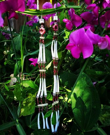 Magenta and pink floral earrings with triple tier dentalium shells and handwoven beargrass. 